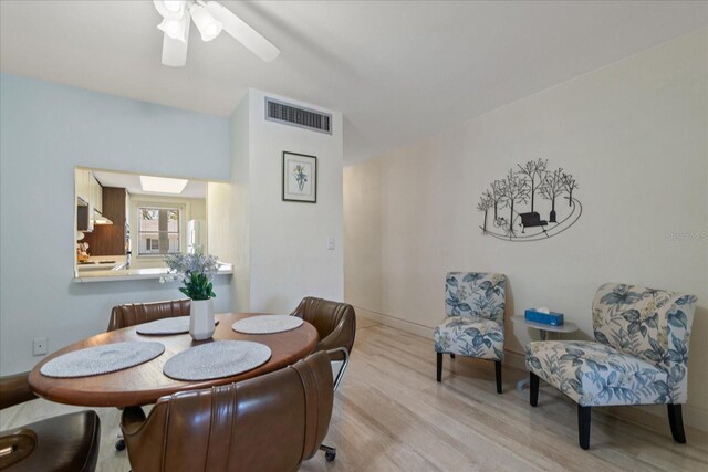 100 Glennes Ln Unit 207, Dunedin, FL 34698 - dining area featuring wood finished floors and a ceiling fan
