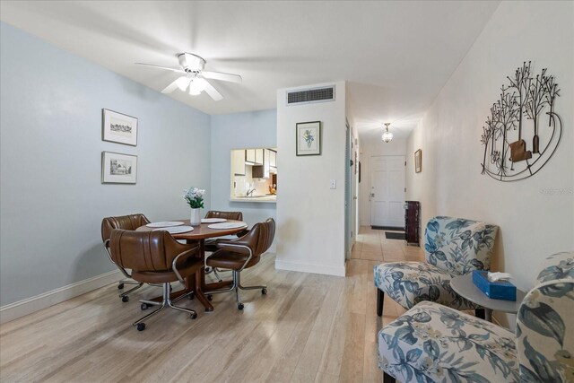 100 Glennes Ln Unit 207, Dunedin, FL 34698 - dining room featuring wood finished floors, baseboards, and ceiling fan