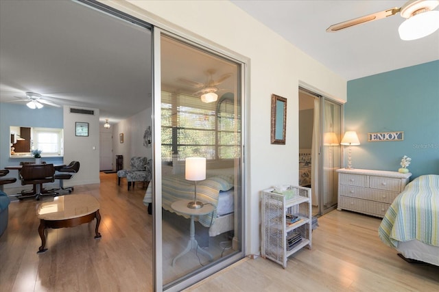 100 Glennes Ln Unit 207, Dunedin, FL 34698 - bedroom with light wood-type flooring and a ceiling fan