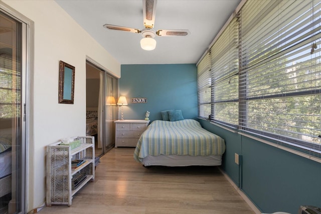 100 Glennes Ln Unit 207, Dunedin, FL 34698 - bedroom with wood finished floors and a ceiling fan