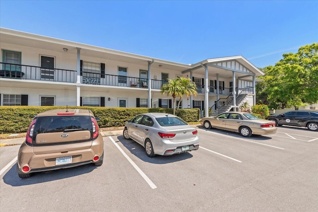 100 Glennes Ln Unit 207, Dunedin, FL 34698 - view of property featuring uncovered parking and stairs