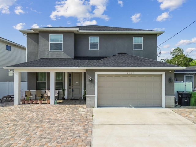 4007 W Gray St, Tampa, FL 33609 - traditional home with driveway, a porch, stucco siding, and fence