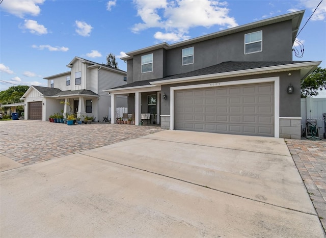 4007 W Gray St, Tampa, FL 33609 - traditional home featuring stucco siding, a porch, and concrete driveway