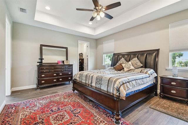 4007 W Gray St, Tampa, FL 33609 - bedroom featuring recessed lighting, a raised ceiling, wood finished floors, visible vents, and baseboards