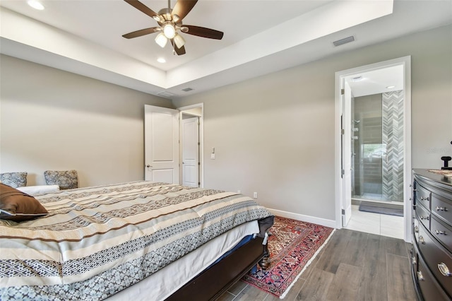 4007 W Gray St, Tampa, FL 33609 - bedroom with baseboards, wood finished floors, a tray ceiling, and recessed lighting