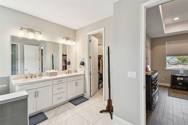 4007 W Gray St, Tampa, FL 33609 - full bathroom featuring a spacious closet, baseboards, a sink, and double vanity
