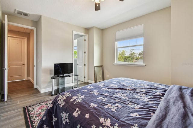 4007 W Gray St, Tampa, FL 33609 - bedroom with wood finished floors, attic access, ceiling fan, baseboards, and visible vents