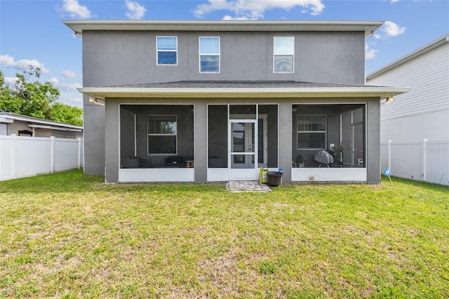 4007 W Gray St, Tampa, FL 33609 - rear view of property featuring a fenced backyard, a sunroom, a yard, and stucco siding