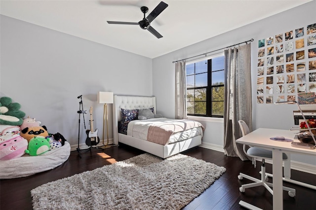 bedroom with dark wood-style flooring, baseboards, and ceiling fan