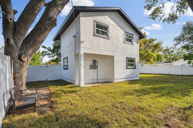 7210 8th Ave N, Saint Petersburg, FL 33710 - rear view of property with a gate, stucco siding, and a fenced backyard
