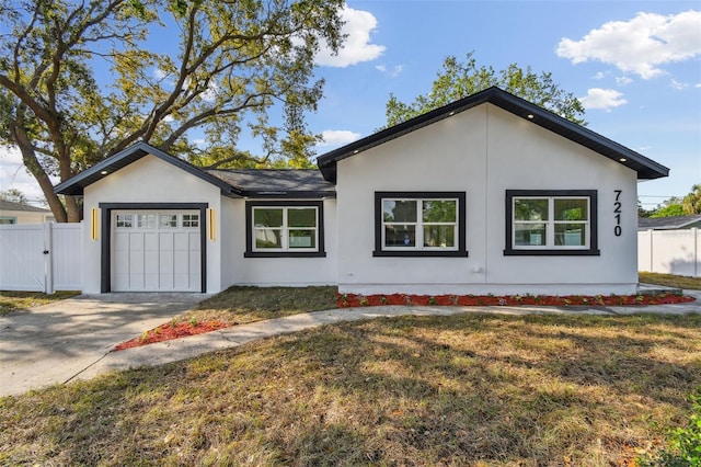 7210 8th Ave N, Saint Petersburg, FL 33710 - view of front of home featuring a garage, stucco siding, and concrete driveway