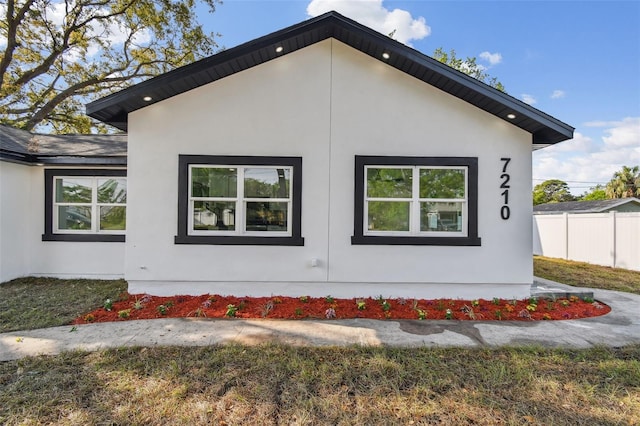 7210 8th Ave N, Saint Petersburg, FL 33710 - view of side of home featuring stucco siding