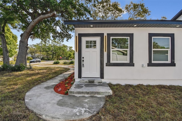 7210 8th Ave N, Saint Petersburg, FL 33710 - property entrance featuring stucco siding and a lawn