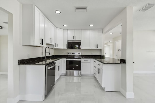 7210 8th Ave N, Saint Petersburg, FL 33710 - kitchen featuring appliances with stainless steel finishes, recessed lighting, white cabinets, and dark stone countertops