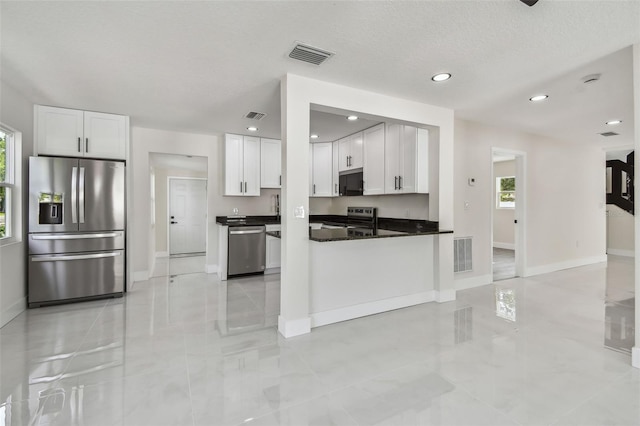 7210 8th Ave N, Saint Petersburg, FL 33710 - kitchen featuring appliances with stainless steel finishes, dark countertops, white cabinetry, recessed lighting, and open floor plan