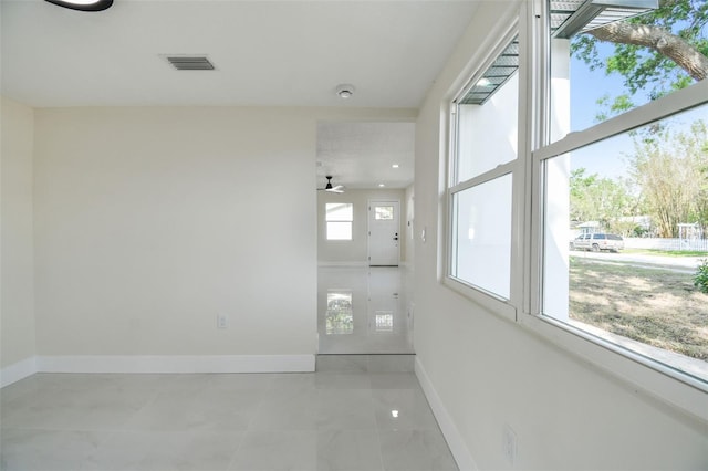 7210 8th Ave N, Saint Petersburg, FL 33710 - spare room featuring light marble finish floors and a ceiling fan