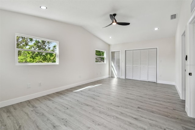 7210 8th Ave N, Saint Petersburg, FL 33710 - unfurnished bedroom with wood finished floors, recessed lighting, vaulted ceiling, two closets, and ceiling fan