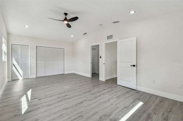 7210 8th Ave N, Saint Petersburg, FL 33710 - unfurnished bedroom with two closets, vaulted ceiling, wood finished floors, recessed lighting, and ceiling fan