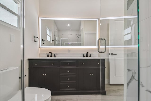 7210 8th Ave N, Saint Petersburg, FL 33710 - full bath featuring a marble finish shower, double vanity, and wood finished floors