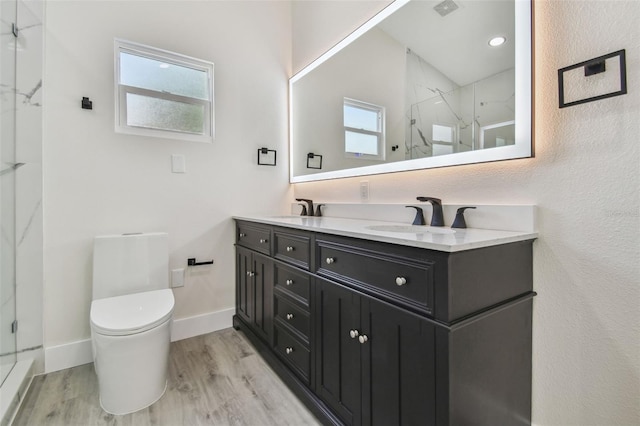7210 8th Ave N, Saint Petersburg, FL 33710 - bathroom featuring a marble finish shower, wood finished floors, and double vanity