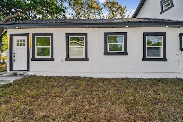7210 8th Ave N, Saint Petersburg, FL 33710 - view of property exterior with stucco siding and a lawn
