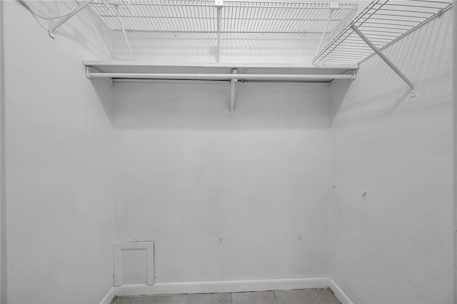 walk in closet featuring light tile patterned flooring