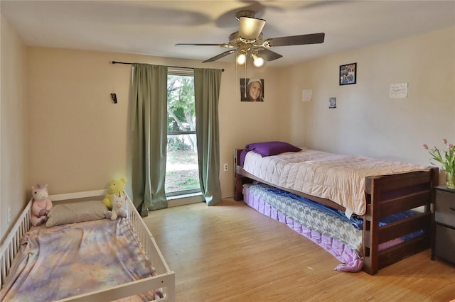 bedroom featuring wood finished floors and a ceiling fan