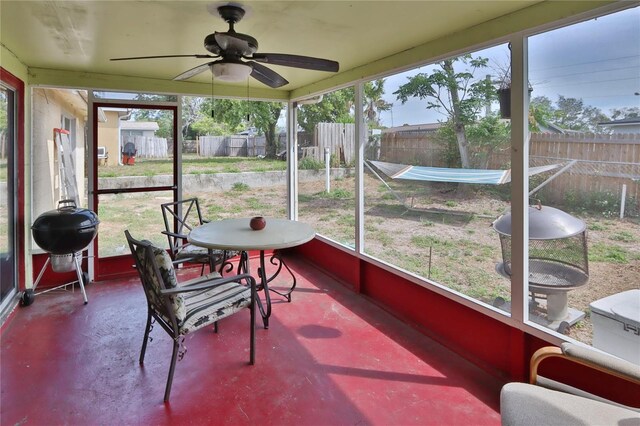sunroom / solarium featuring a wealth of natural light and ceiling fan