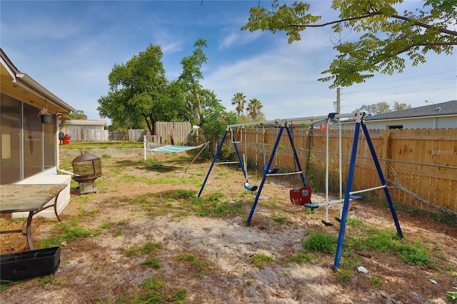 view of yard with fence and a playground