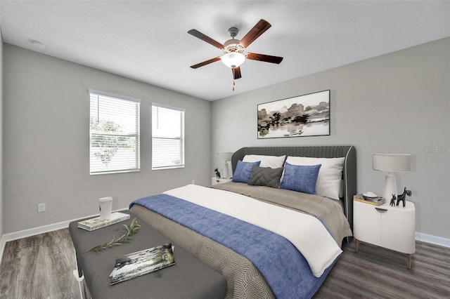 bedroom featuring wood finished floors, baseboards, and a ceiling fan