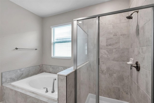 full bath with a garden tub and a stall shower