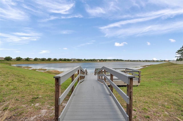 view of dock featuring a yard and a water view