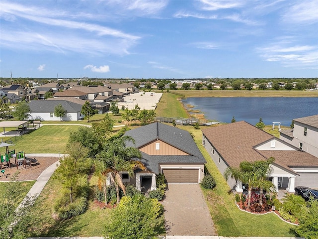 drone / aerial view with a water view and a residential view