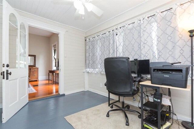 office space with baseboards, wood finished floors, and a ceiling fan