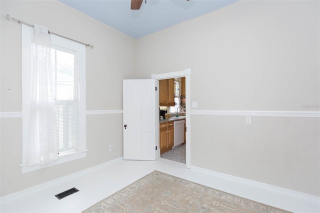 empty room with a ceiling fan, a sink, and visible vents