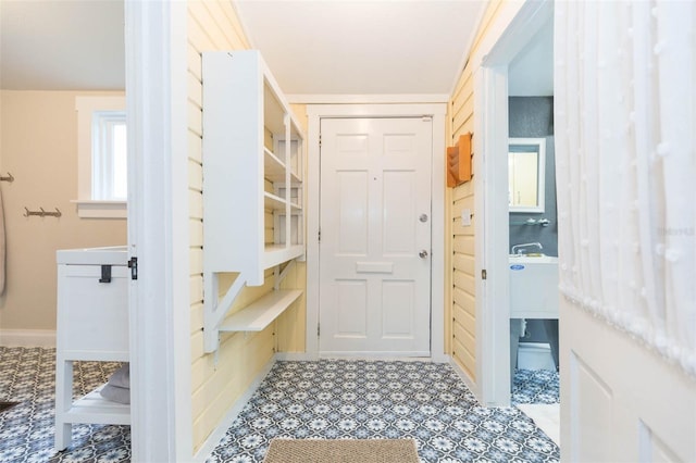 interior space featuring baseboards and tile patterned floors