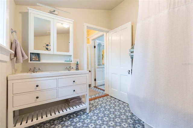 full bathroom with double vanity and a sink
