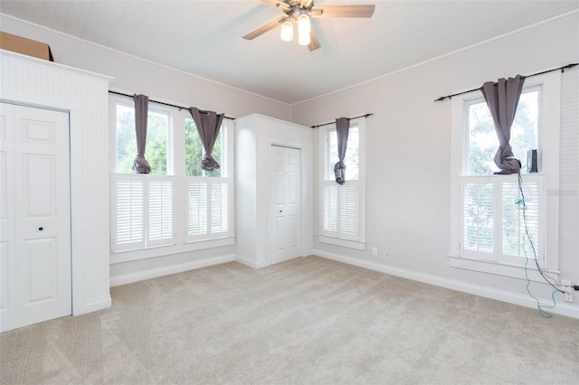 spare room featuring baseboards, carpet flooring, and a ceiling fan