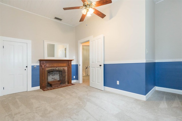 unfurnished living room with a fireplace with flush hearth, high vaulted ceiling, carpet, visible vents, and a ceiling fan