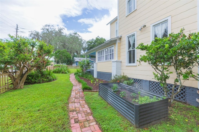 view of yard with fence and a garden