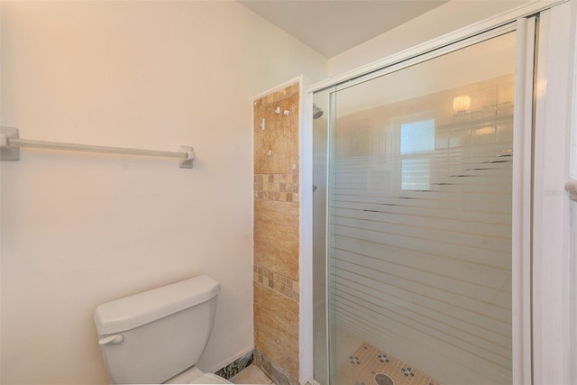full bath with toilet and a stall shower