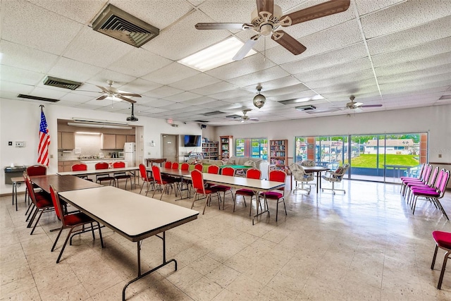 dining room with a paneled ceiling, light floors, ceiling fan, and visible vents
