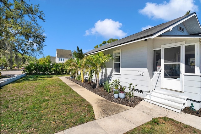 705 28th St N, Saint Petersburg, FL 33713 - view of side of property with entry steps, crawl space, and a yard