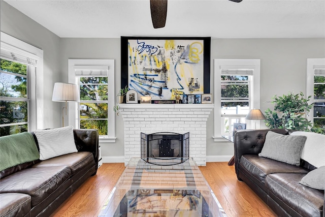 705 28th St N, Saint Petersburg, FL 33713 - living area featuring a fireplace, a wealth of natural light, and hardwood / wood-style flooring