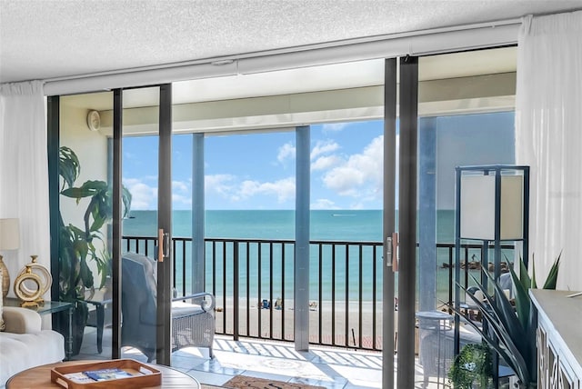 interior space featuring a water view and a view of the beach