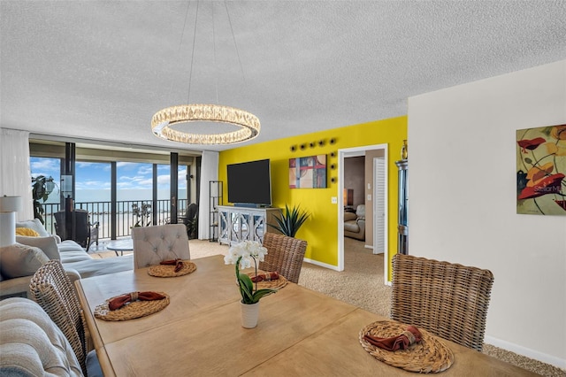 dining space featuring a textured ceiling, a chandelier, baseboards, and carpet