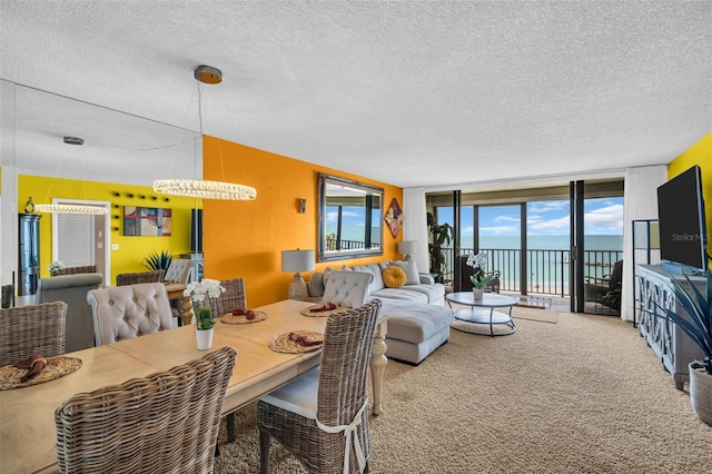 7100 Sunset Way Unit 303, St Pete Beach, FL 33706 - dining area with an inviting chandelier, carpet flooring, and a textured ceiling