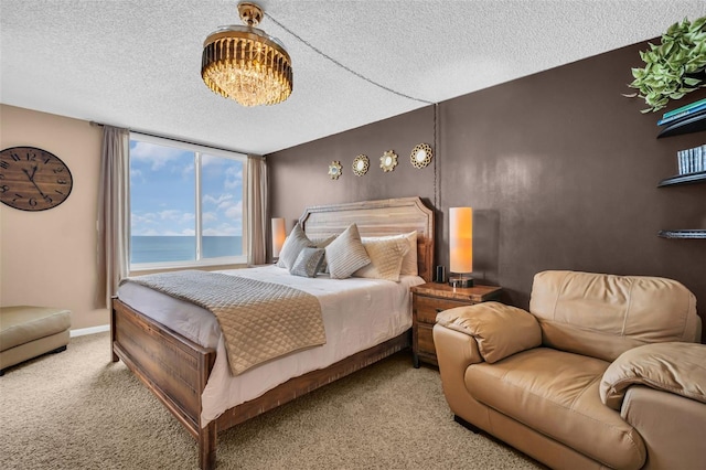 carpeted bedroom with a water view and a textured ceiling