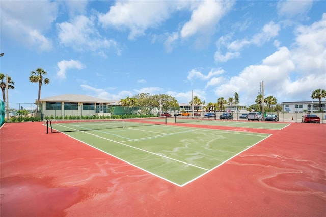 view of tennis court featuring fence and community basketball court