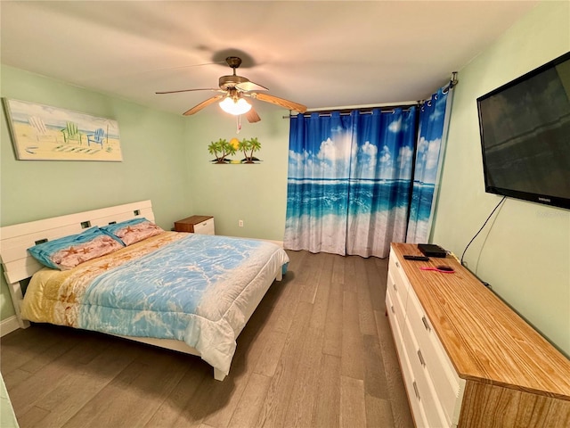 bedroom featuring a ceiling fan and wood finished floors